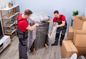 team of movers and packers packing material.